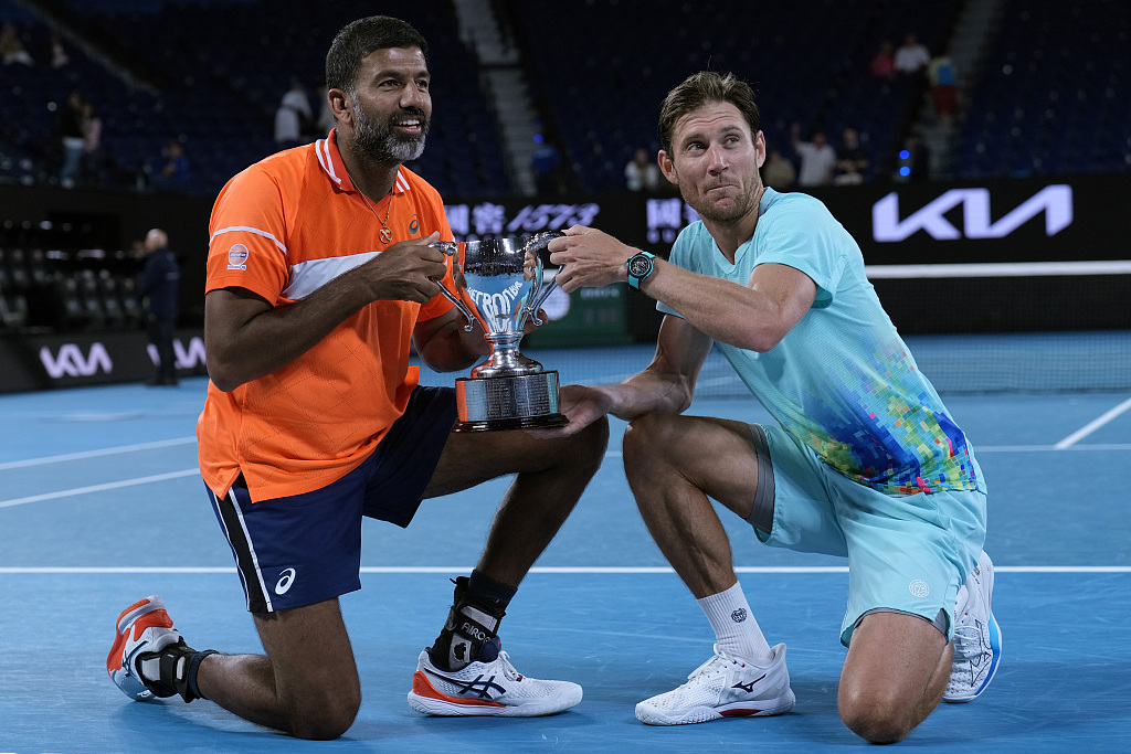 Rohan Bopanna (L) of India and Matthew Ebden of Australia celebrate after winning the men's doubles title at the Australian Open at Melbourne Park in Melbourne, Australia, January 27, 2024. /CFP