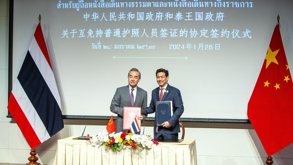 Chinese Foreign Minister Wang Yi, also a member of the Political Bureau of the Communist Party of China Central Committee, signs an agreement on mutual visa exemption with Thai Deputy Prime Minister and Minister of Foreign Affairs Parnpree Bahiddha-Nukara after an annual consultation in Bangkok, Thailand, January 28, 2024. /Xinhua