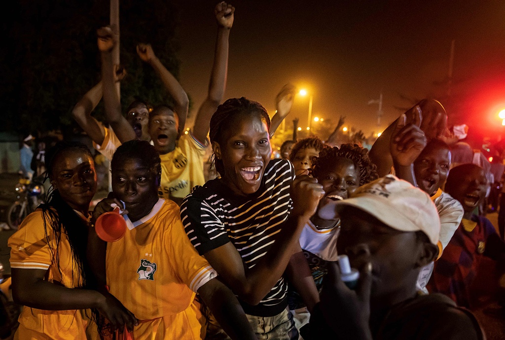 Cote d'Ivoire supporters react after the their team beat Senegal on penalties to reach the quarterfinals of the Africa Cup of Nations, on a street in Korhogo on January 29, 2024. /CFP