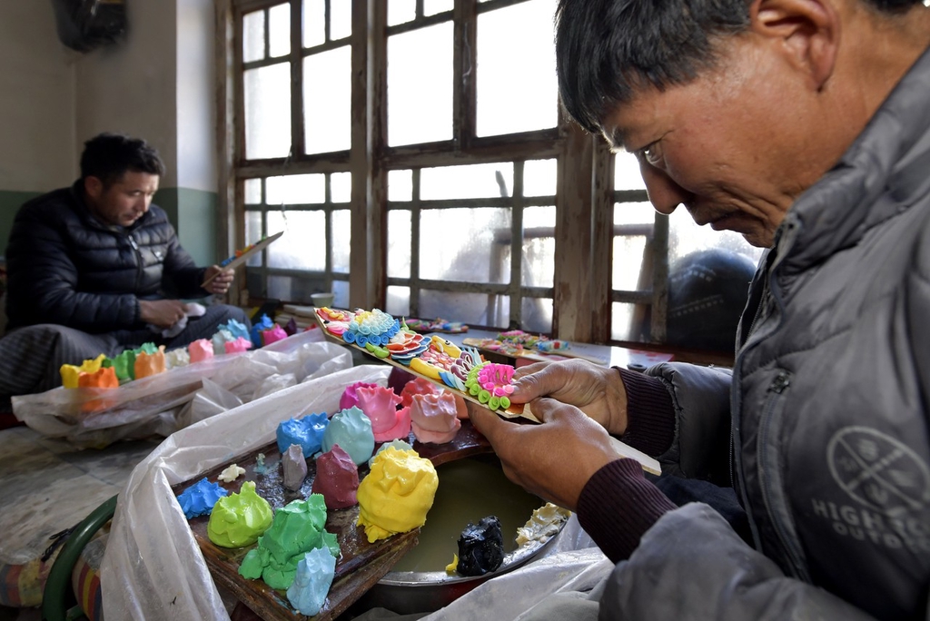 photo shows craftsmen shaping butter sculptures in Lhasa, capital of southwest China's Xizang Autonomous Region, on January 30, 2024. /IC