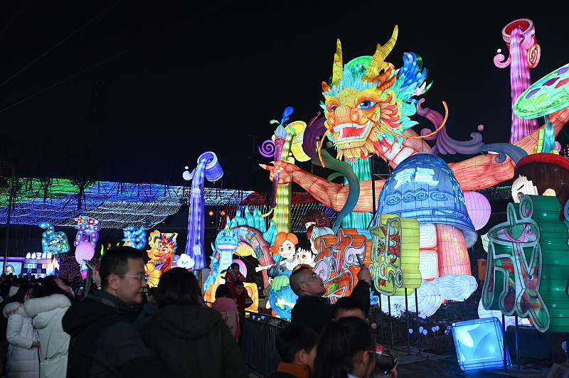 People flock to the 30th Zigong International Dinosaur Lantern Festival for a preview of this year's New Year celebrations in Zigong, Sichuan Province, January 31, 2024. /CFP