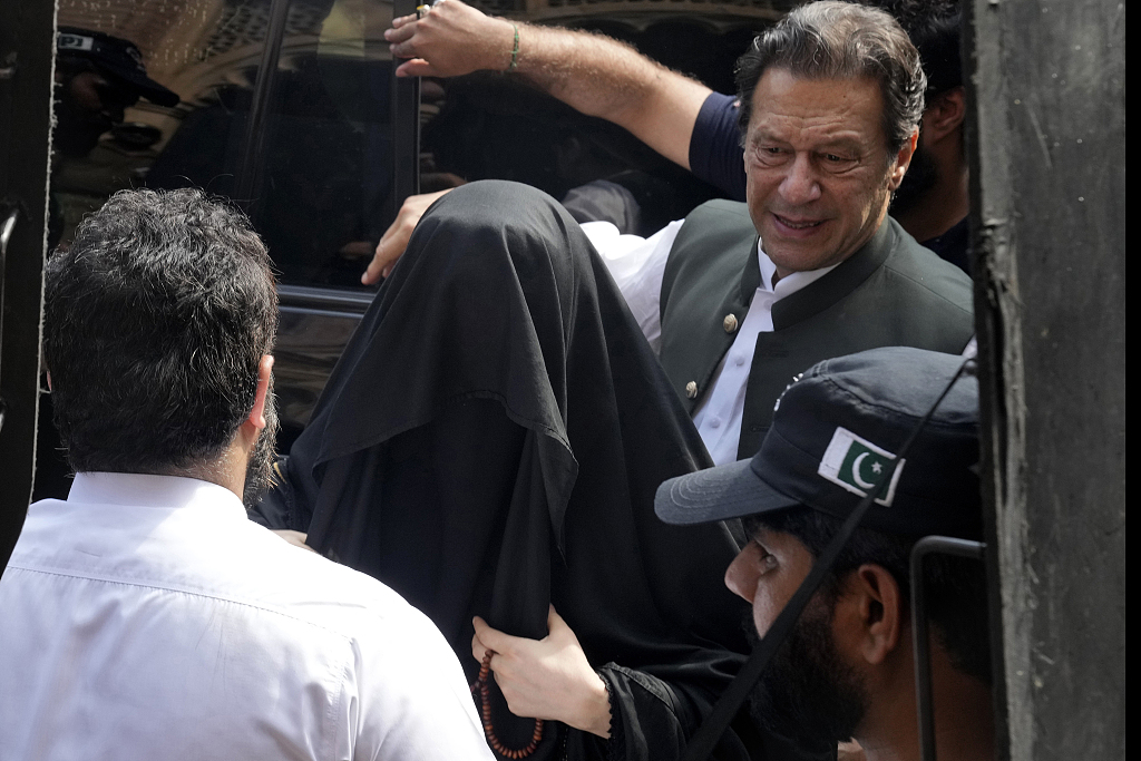 Pakistan's former Prime Minister Imran Khan, right, with his wife Bushra Bibi, center, arrive in a court in Lahore, Pakistan, June 26, 2023. /CFP