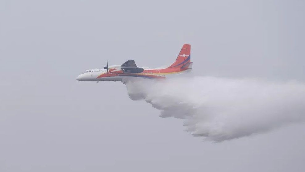 An MA60 firefighting aircraft drops water in the sky above Suining City, southwest China's Sichuan Province, January 27, 2024. /China Aviation News