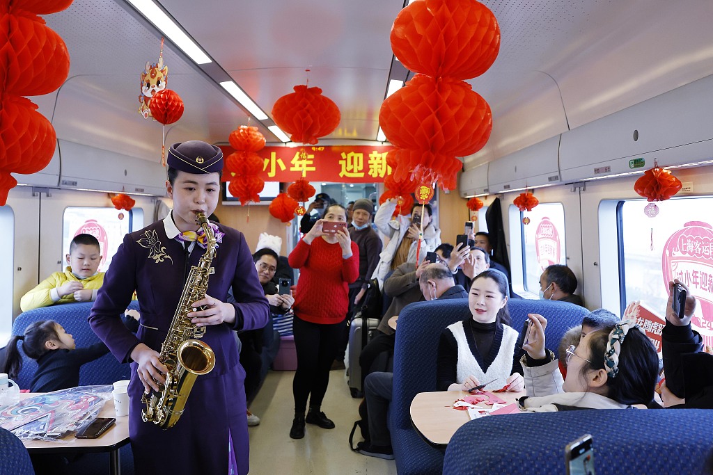 A photo taken on February 2, 2024 shows train conductor Hua Min performing a saxophone solo on Train D3107. /CFP