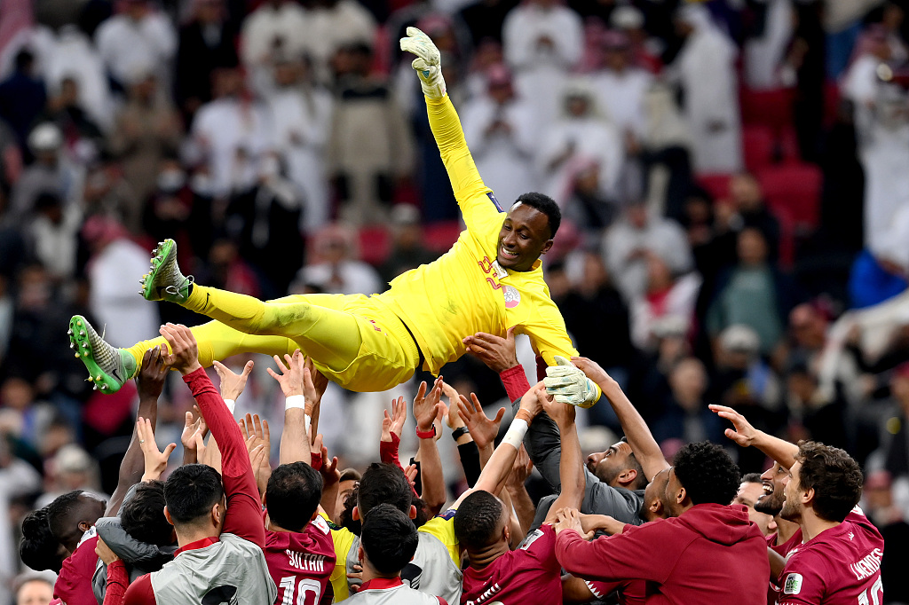 Qatari players celebrate by throwing Meshaal Barsham in the air following the team's victory in the AFC Asian Cup quarterfinal round against Uzbekistan in Al Khor, Qatar, February 3, 2024. /CFP
