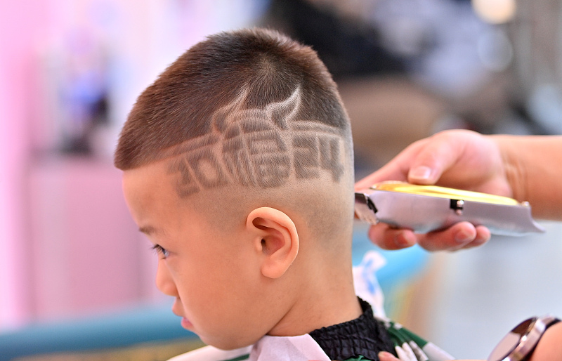 A boy gets a new creative hairstyle at a barbershop in Changchun City, Jilin Province, February 4, 2024. /CFP