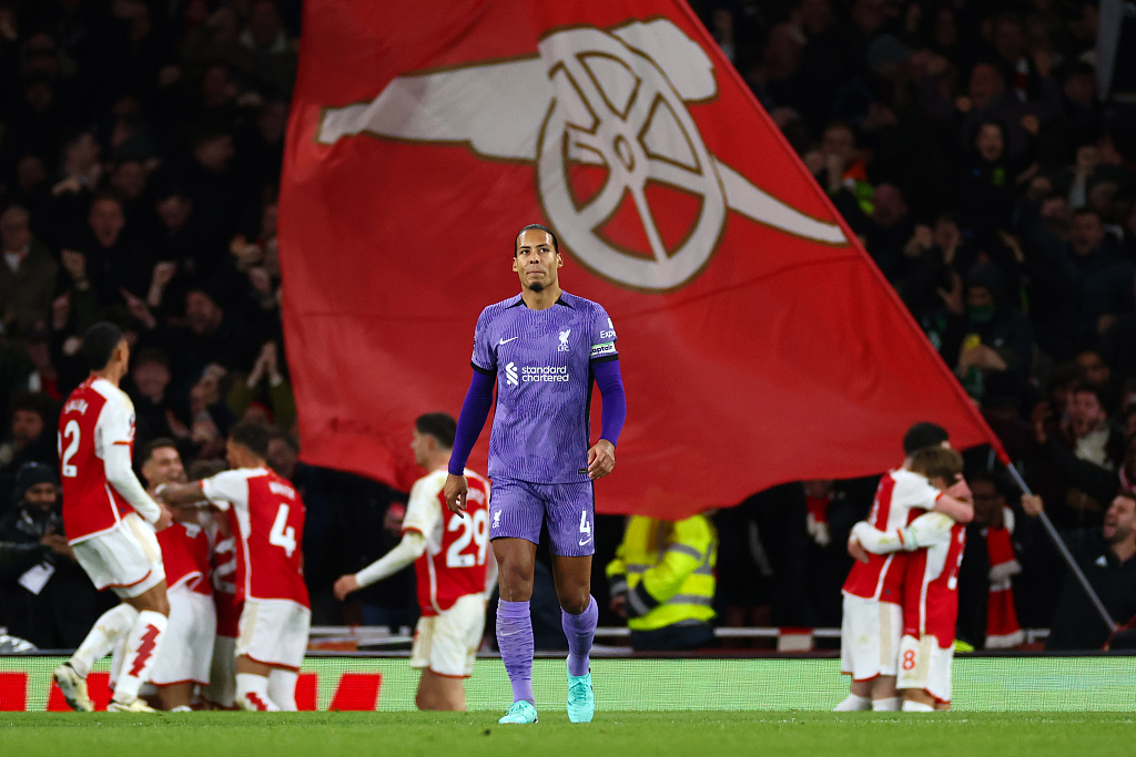 Virgil van Dijk of Liverpool looks dejected as Arsenal players celebrate during their Premier League clash with Arsenal at Emirates Stadium in London, England, February 4, 2024. /CFP