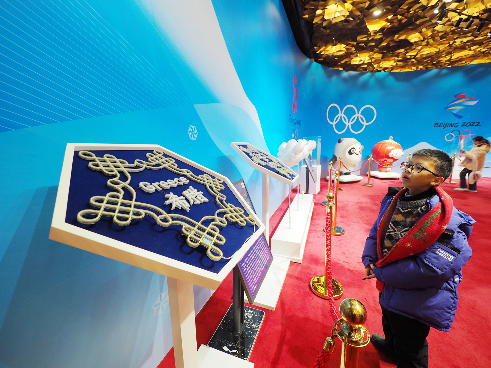 A boy looks at an exhibition on the Beijing Winter Olympics and Paralympics at the National Stadium in Beijing on February 5, 2024. /IC