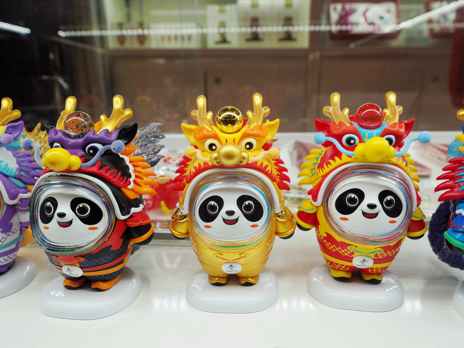 Licensed products featuring the Chinese zodiac dragon version of the Beijing Winter Olympic Games mascot Bing Dwen Dwen are seen for sale at an exhibition at the National Stadium in Beijing on February 5, 2024. /IC
