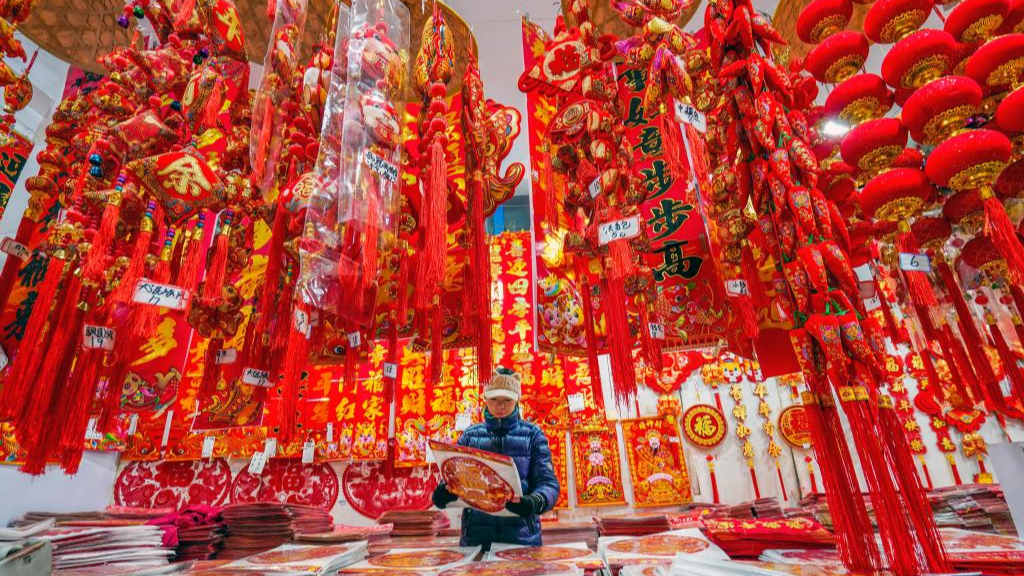 A customer selects decorations for Spring Festival at a market in Yutian County, north China's Hebei Province, January 13, 2024. /Xinhua