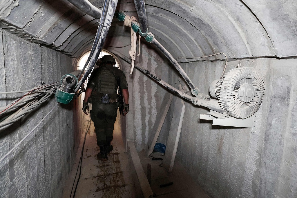 This picture taken during a media tour organized by the Israeli military on February 8, 2024, shows Israeli soldiers inside a tunnel that the army claimed is a 