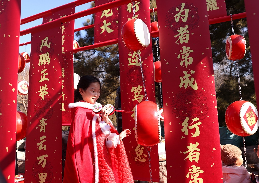 A girl dressed in traditional Chinese costume poses for photos at the temple fair at Badachu Park in the Shijingshan District of Beijing on February 10, 2024, Chinese New Year's Day. /CFP