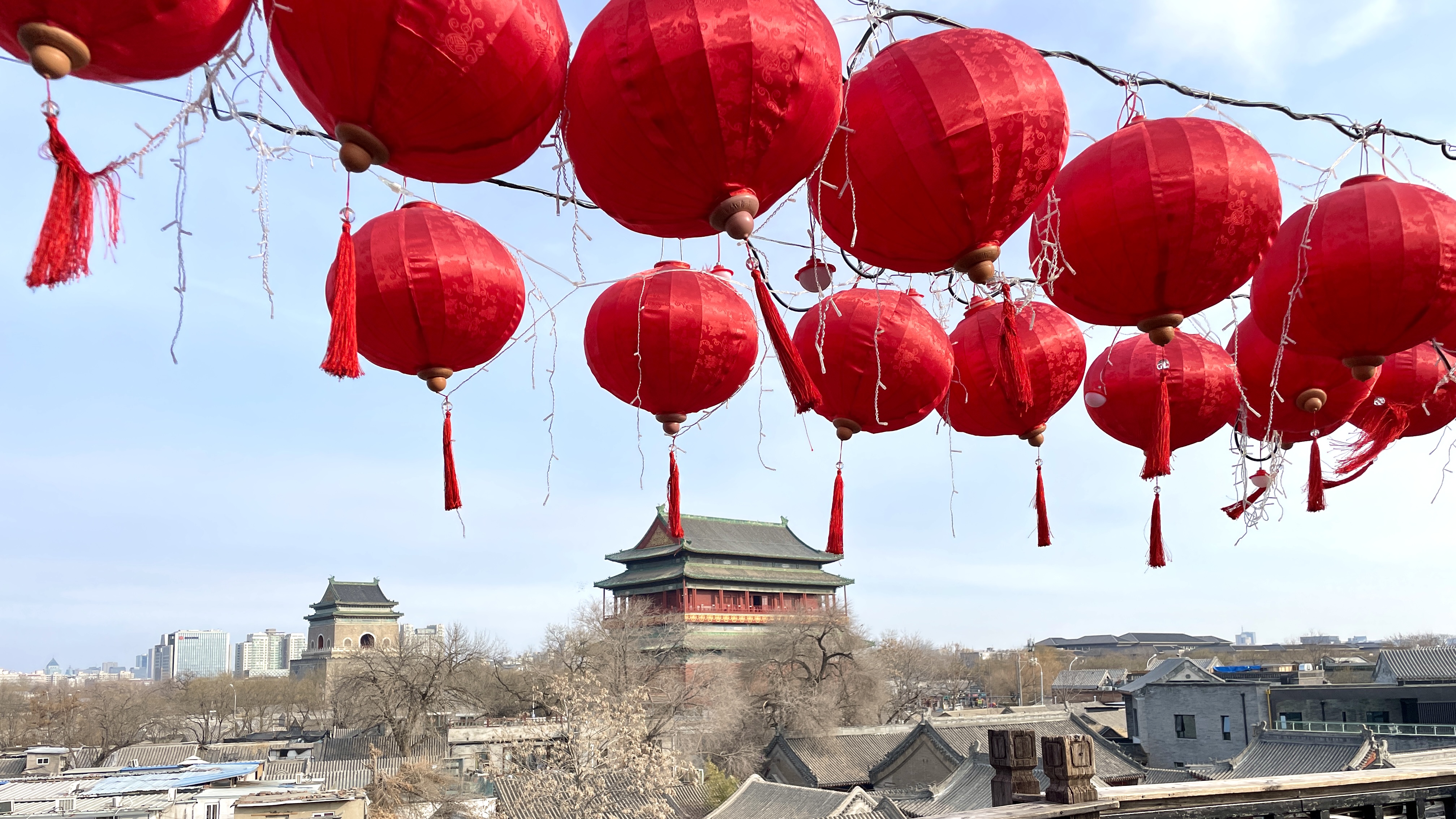 Bright lanterns are seen hanging from a rooftop overlooking Beijing's iconic Bell and Drum Towers. /CGTN