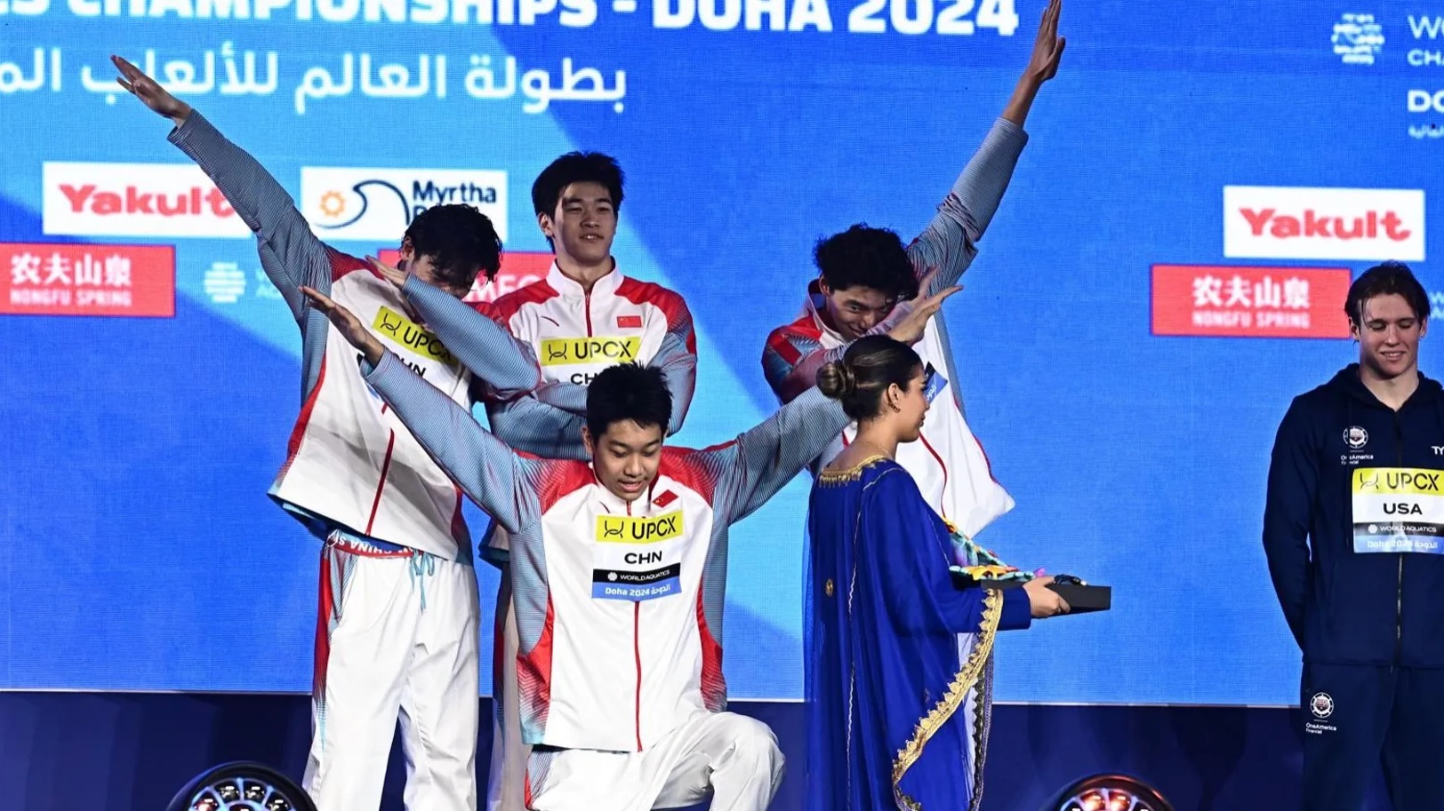 China's athletes celebrate on the podium after winning the men's 4x100m freestyle relay final at the World Aquatics Championships in Doha, Qatar, February 11, 2024. /CFP