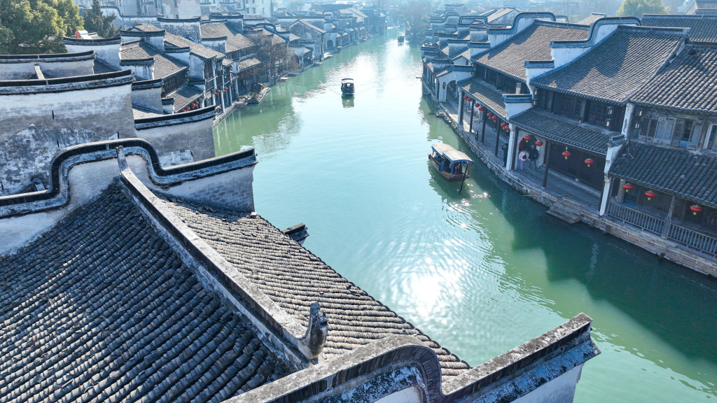 A photo shows boats sailing down a canal in Nanxun Ancient Town, Huzhou, Zhejiang Province, February 11, 2024. /CFP