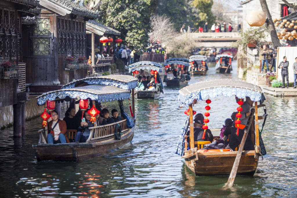 A photo shows visitors enjoying boat rides in Nanxun Ancient Town, Huzhou, Zhejiang Province, February 11, 2024. /CFP