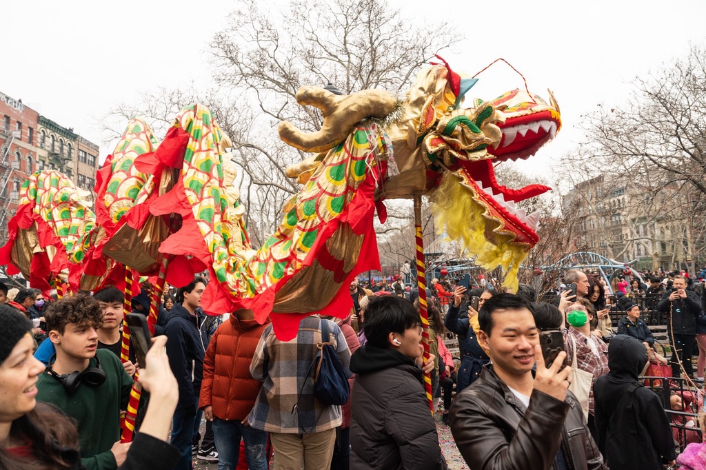 A dragon dance costume is paraded through the streets of Chinatown in New York City, United States, February 10, 2024. /IC