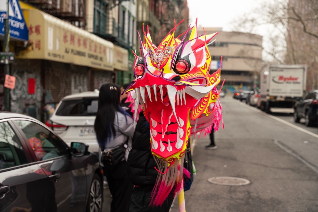 A dragon head crafts is held up in the streets of Chinatown, New York City, United States, February 10, 2024. /IC