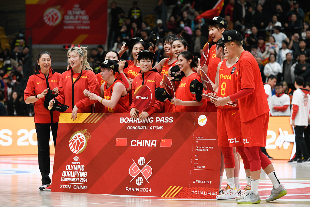 Team China celebrate with a giant Boarding Pass to the Paris 2024 Olympic Games during the FIBA women's Olympic qualifying tournament in Xi'an, China, February 11, 2024. /CFP