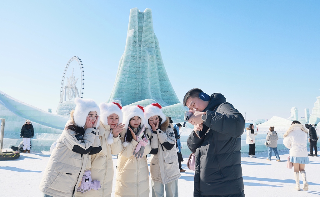 Visitors take photos with sculptures at the Harbin Ice and Snow World on February 15, 2024. /CFP