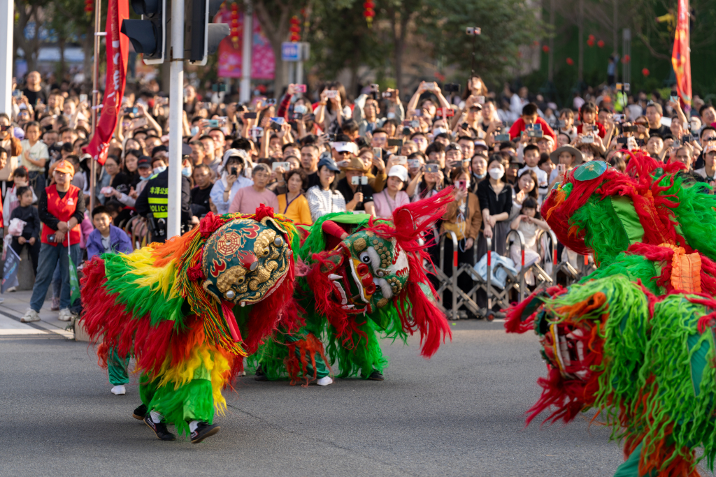 A lion dance is performed during the festive parade 