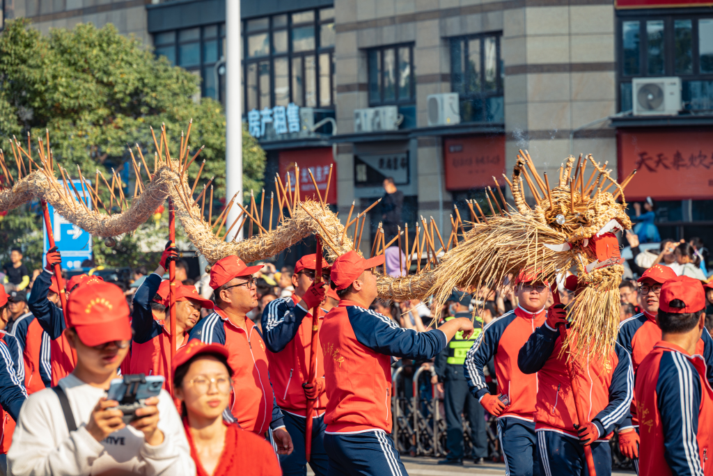 A straw-woven dragon is seen during the festive parade 