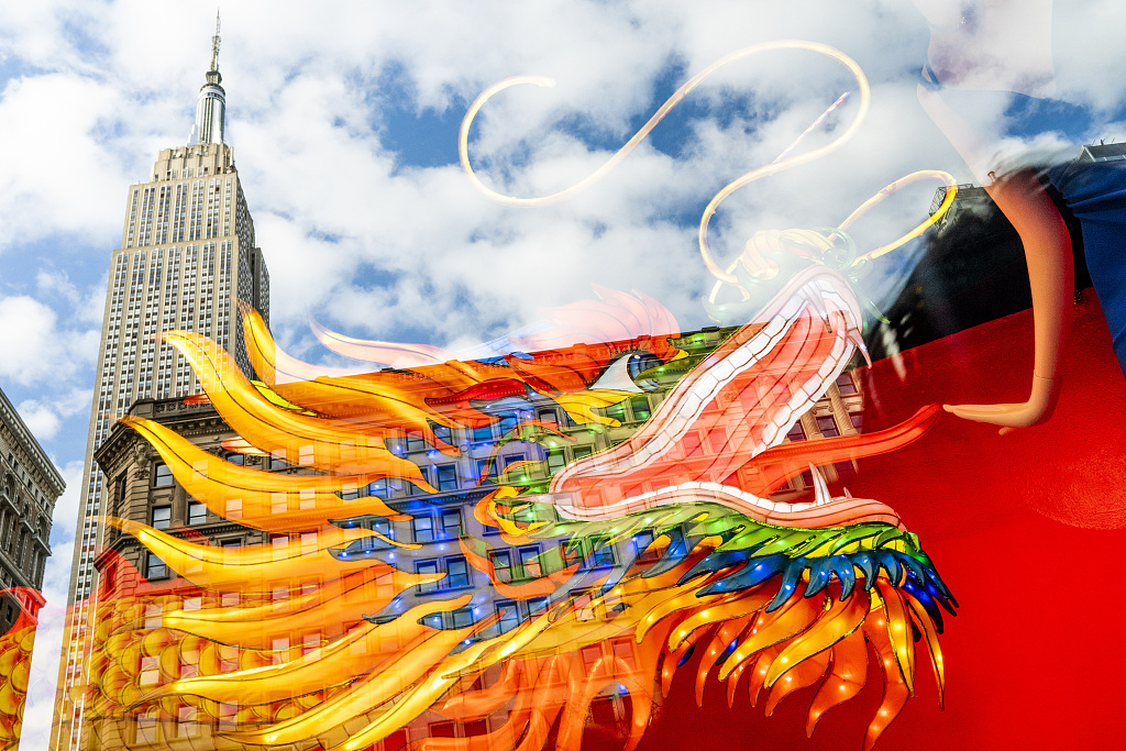 The Empire State Building and a dragon are reflected on a window while people commemorate the Year of the Dragon during the Spring Festival celebrations in New York, United States, February 9, 2024. /CFP
