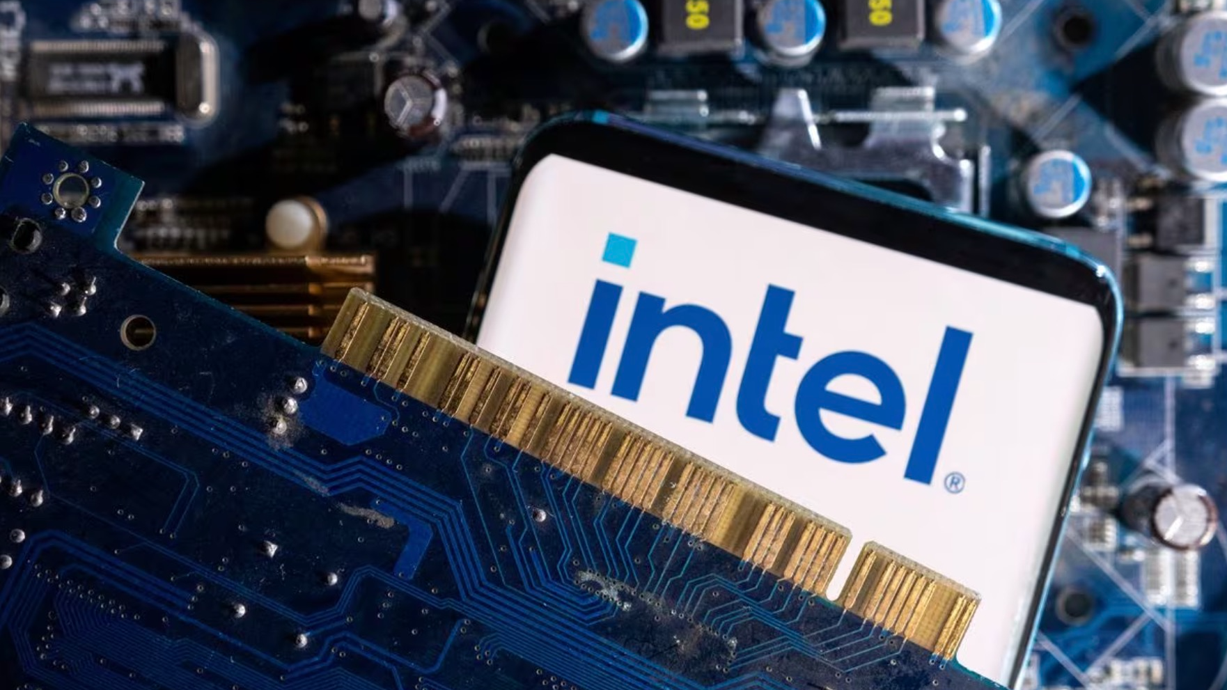 An illustration showing a smartphone with a displayed Intel logo is placed on a computer motherboard, March 6, 2023. /Reuters
