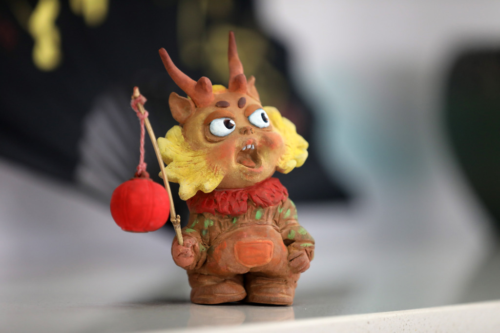 A ceramic dragon doll holding a red lantern is pictured on February 18, 2024. /CFP