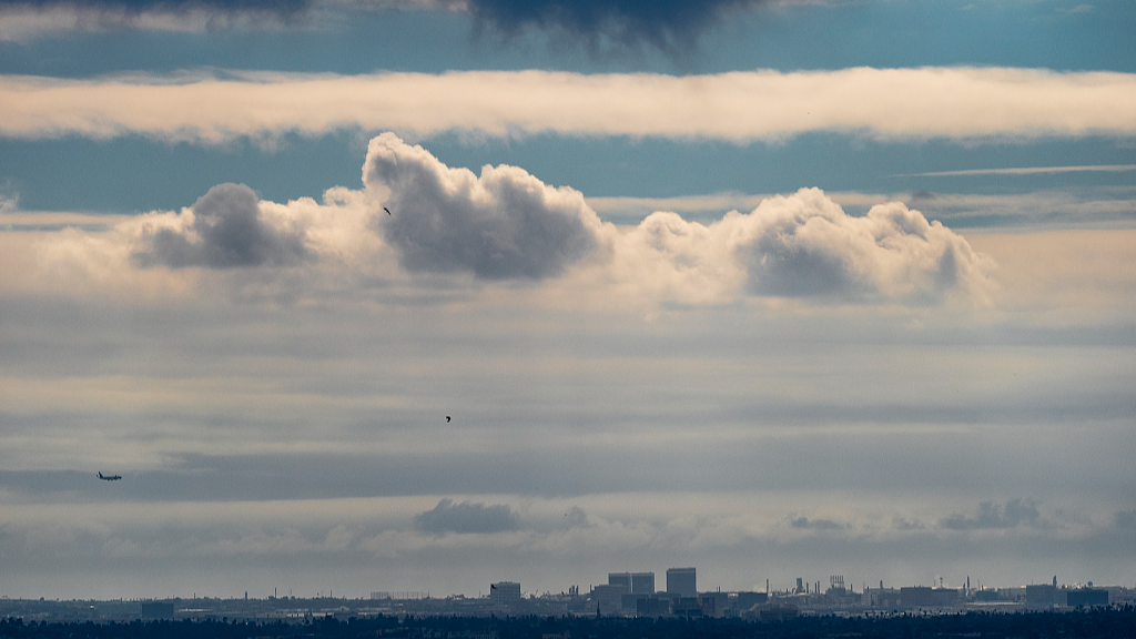A plane descends into Los Angeles International Airport as low clouds gather over the Pacific ahead of forecasted rain in Los Angeles on February 18, 2024. /CFP