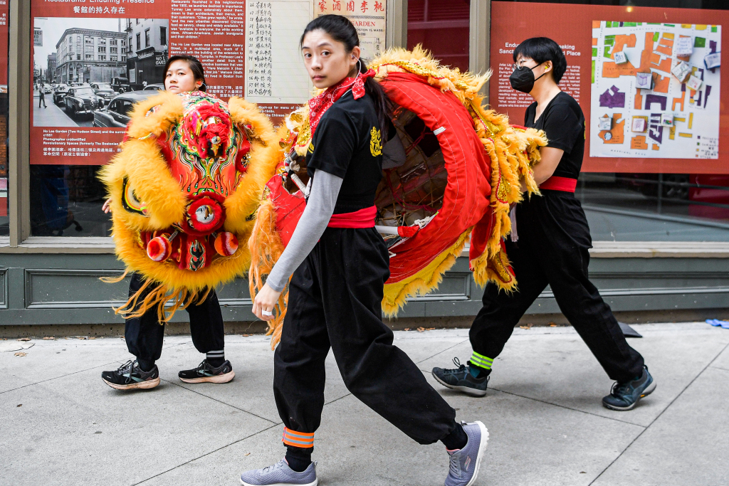 Performers are seen holding lion dance costumes on a sidewalk in Boston, United States, February 18, 2024. /CFP