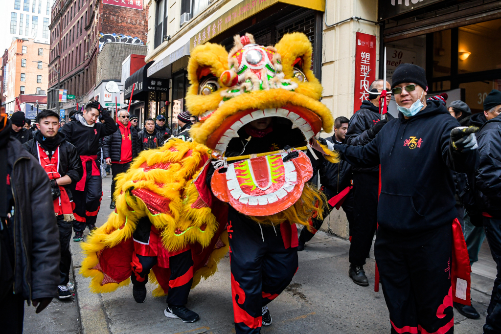 Lion dance performers are seen on a sidewalk in Boston, United States, February 18, 2024. /CFP