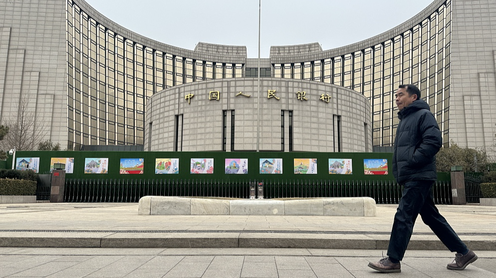 A man walks past the headquarters of the People's Bank of China, Beijing, China, February 20, 2024. /CFP