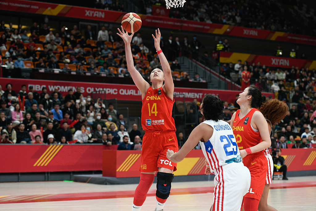 Li Yueru (#14) of China shoots in the women's qualification game against Puerto Rico for the 2024 Paris Olympic basketball tournament in Xi'an, northwest China's Shaanxi Province, February 11, 2024. /CFP
