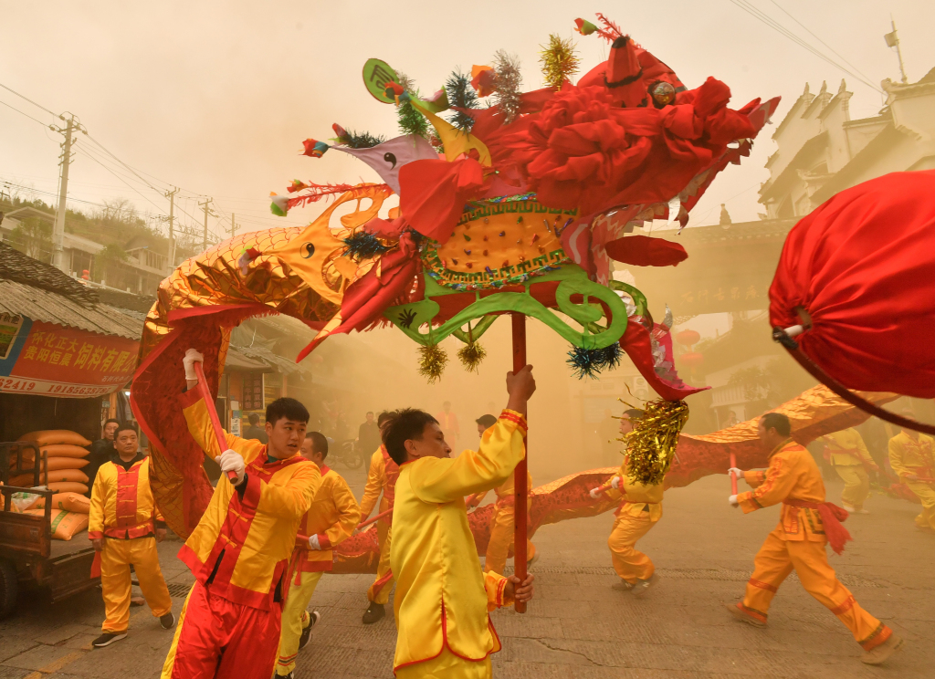 A troupe dances with a dragon costume in Tongren, Guizhou Province, February 20, 2024. /CFP