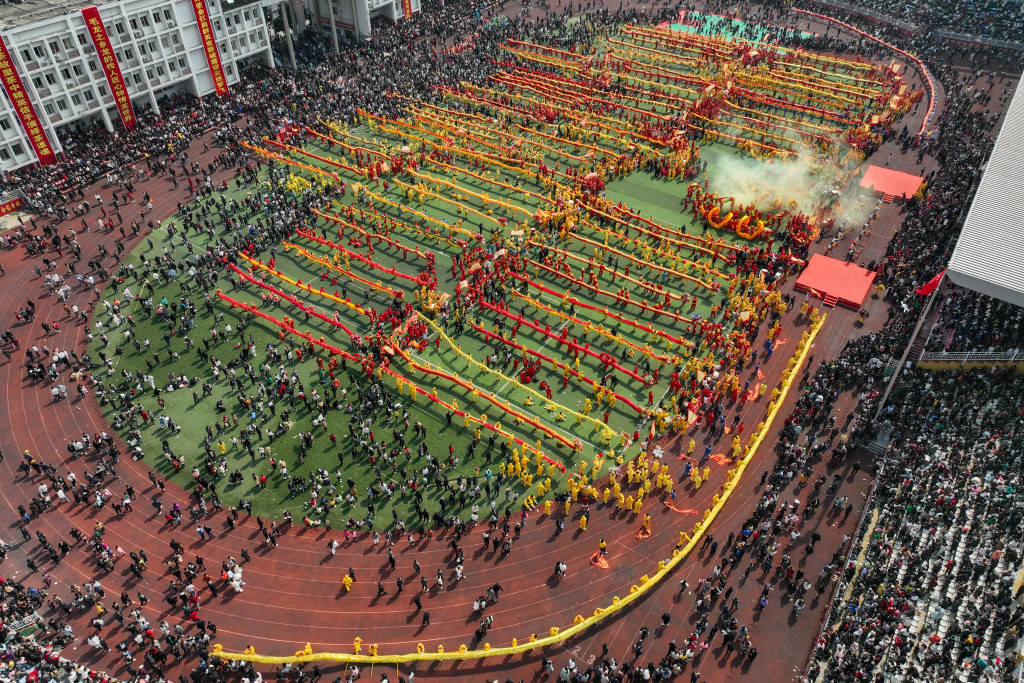Dragon dance troupes line up at a county stadium in Tongren, Guizhou Province, February 20, 2024. /CFP