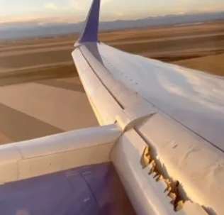 A screenshot of a video taken from a United Airlines Boeing plane shows a piece of the wing's flap missing. /Kevin Clarke via China Media Group