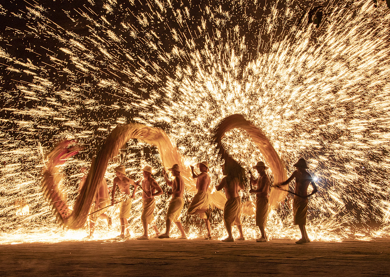 A file photo shows folk artists performing a dragon dance and molten iron throwing show in Chengdu, Sichuan Province. /CFP
