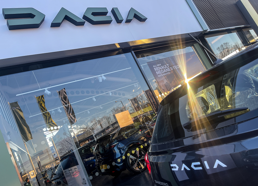 The Romanian car maker Dacia logo is displayed above a dealership in Bristol, England, February 26, 2023. /CFP