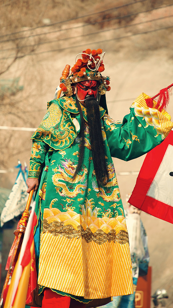 A stilt walker brings viewers an eye-catching performance as a part of the Shehuo parade held on a street in Lanzhou, Gansu Province, on February 16, 2024. It is a time-honored tradition to celebrate Chinese New Year. /CFP  