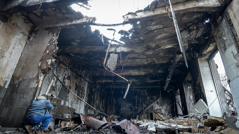 Journalists film the destroyed sewing factory after a night-time drone attack in the port city of Odesa, Ukraine, February 23, 2024. /CFP