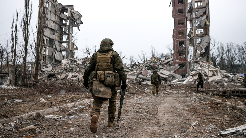 Russian servicemen are seen by a destroyed building in the city of Avdeyevka on February 17, 2024. /CFP