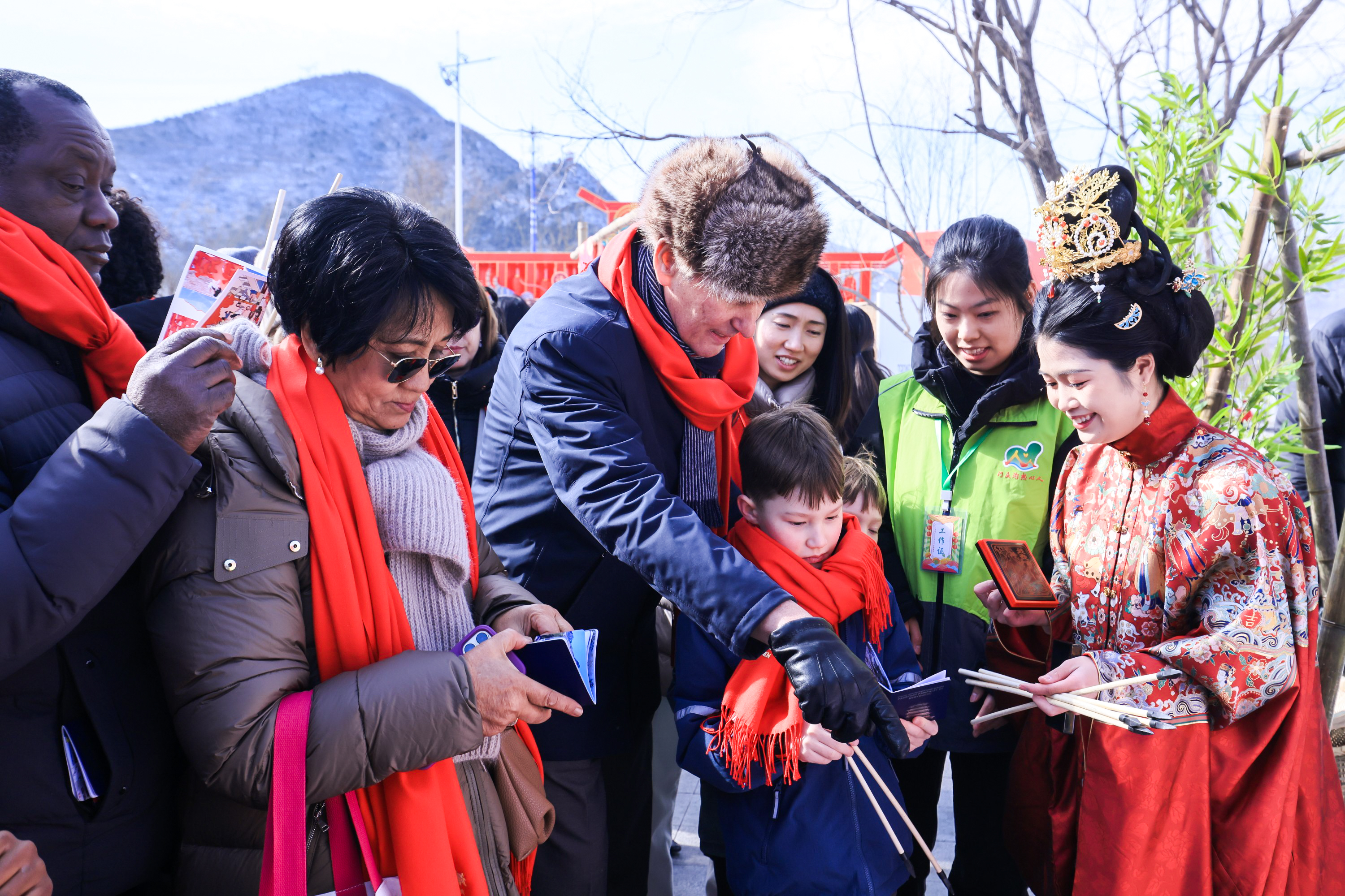 Diplomats and their families collect stamps and play pitch-pot games at a Lantern Festival cultural fair in Beijing on February 23, 2024. /Photo provided to CGTN