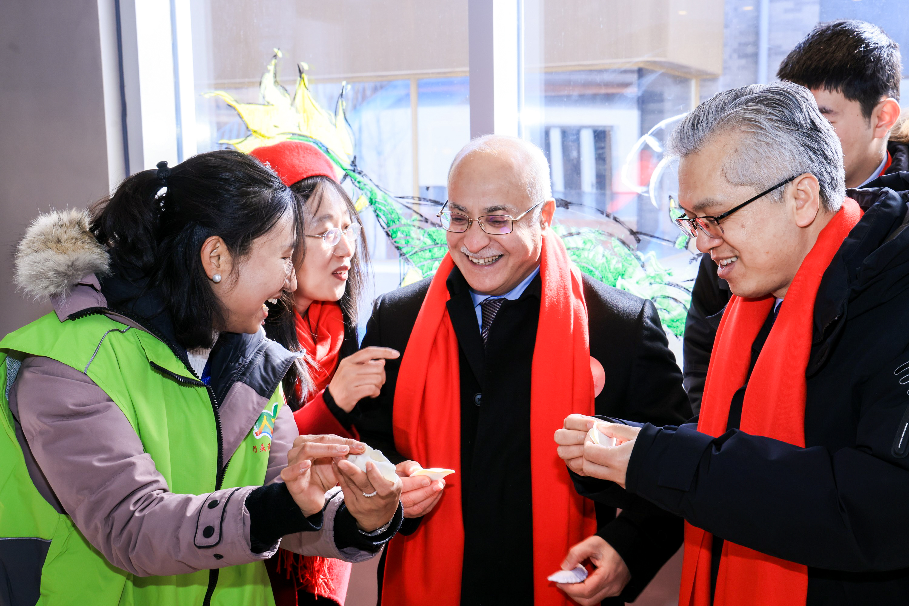 Diplomats and their families learn to make dumplings at a Lantern Festival cultural fair in Beijing on February 23, 2024. /Photo provided to CGTN