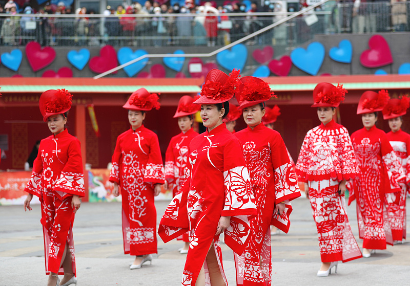 Models show off red qipao featuring creative paper-cut patterns in Qingdao City, Shandong Province, February 24, 2024. /CFP