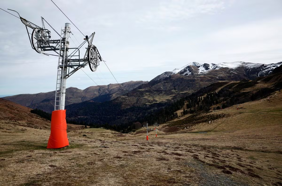 A closed ski lift amid a snowless mountainside on a mild winter day at the Hautacam ski resort in Beaucens, Hautes-Pyrenees, southwestern France, February 21, 2024. /Reuters