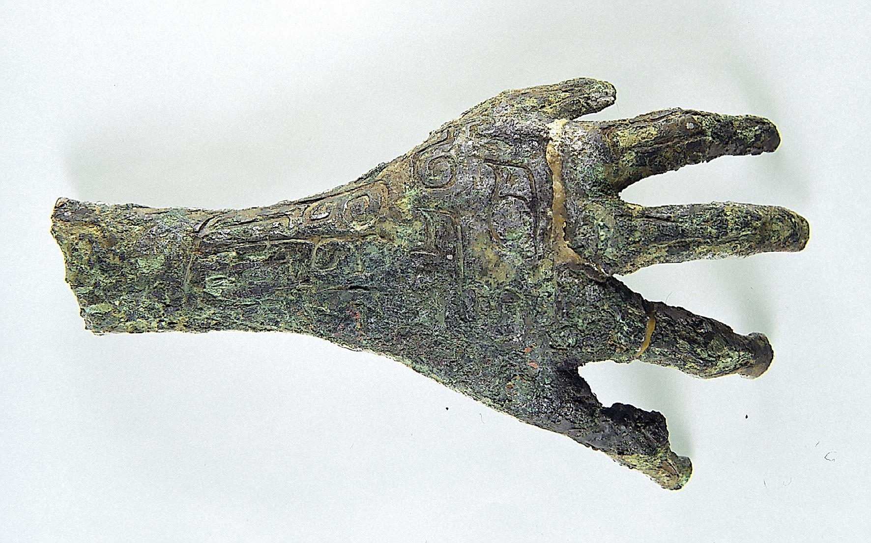 A delicate hand-shaped bronze relic is on display at the new building of the Yinxu Museum in Anyang, Henan Province. /CMG