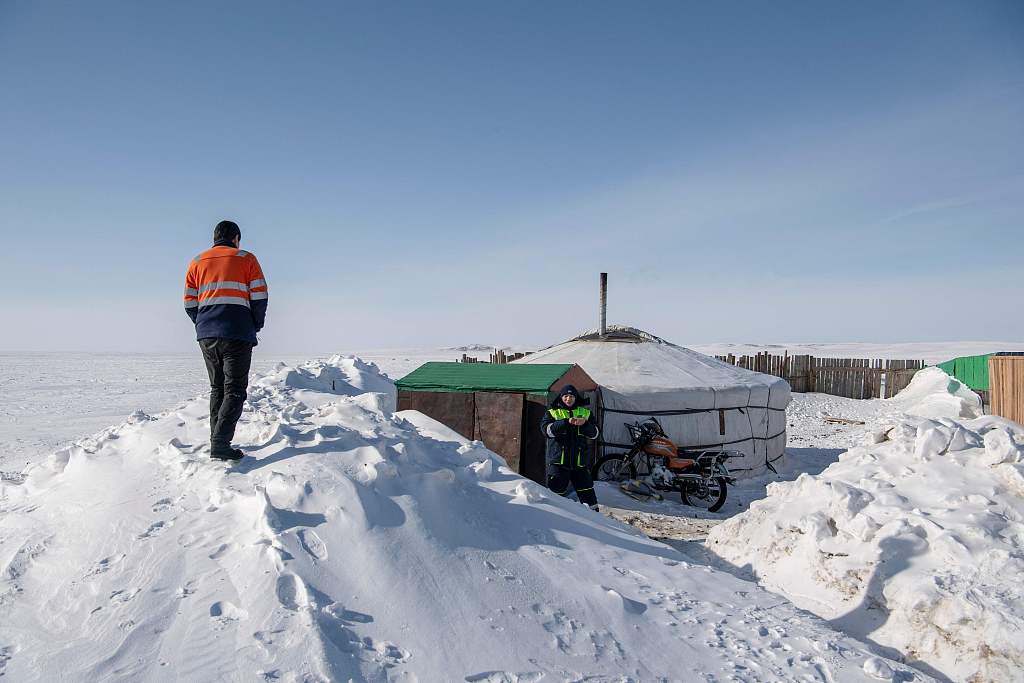 Picture taken on February 22, 2024 shows herdsmen standing near a traditional yurt tent amid extremely cold weather conditions in Bayanmunkh, in Mongolia's Khentii Province. /CFP