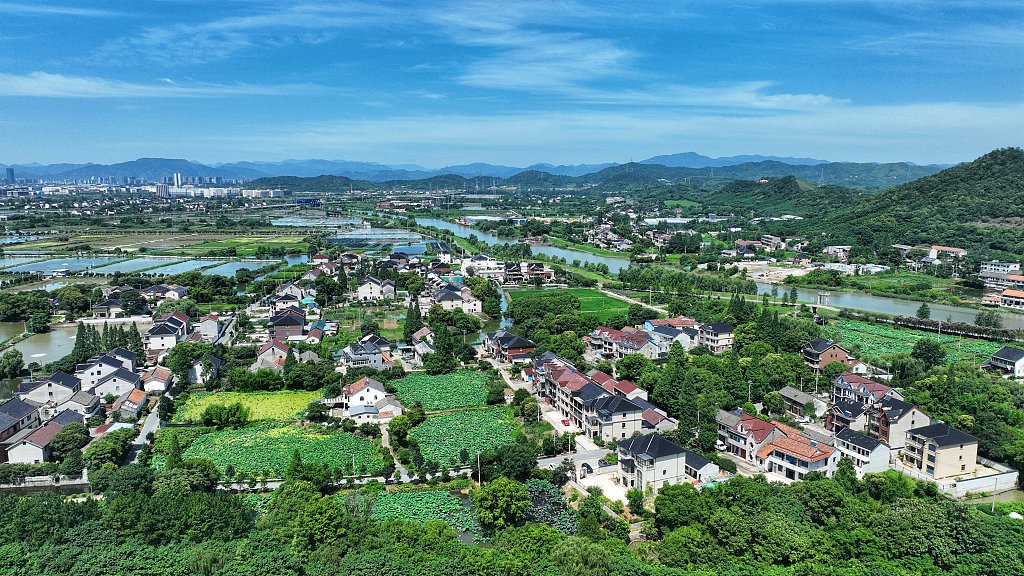 Fuxi Street in Wangmushan Village, Deqing County, presents a picturesque rural summer landscape, with its village, waterways, and lotus ponds, in Huzhou, China./CFP