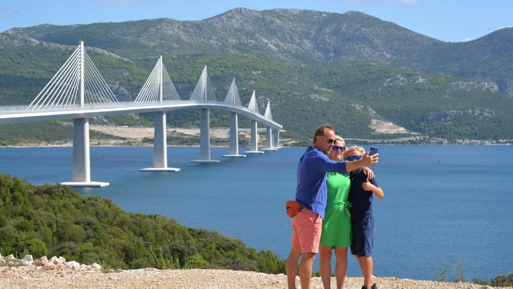 People take photos in front of Peljesac Bridge, built by a Chinese consortium led by the China Road and Bridge Corporation, in Komarna, Croatia, August 29, 2023. /Xinhua